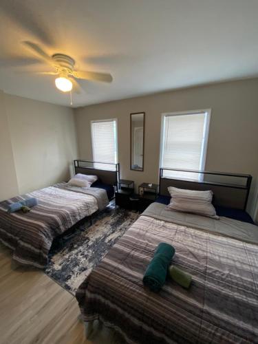 a bedroom with two beds and a ceiling fan at The Heart house in Indianapolis