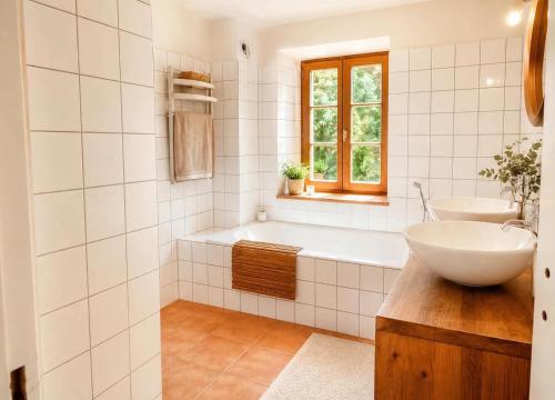 a white bathroom with a sink and a tub and a sink at Villa Piscine et Jaccuzzi - Vue Panoramique in Juillac