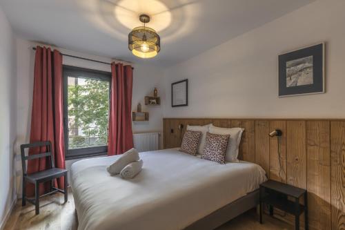 a bedroom with a bed with a stuffed animal on it at Canopee 206 - by Care Concierge in Saint-Gervais-les-Bains