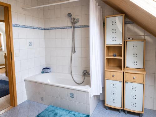 a bathroom with a shower and a bath tub at Urlaub mit Hund auf dem Bauernhof Hofswald in Euscheid