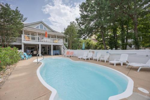 a large swimming pool in front of a house at 4096 - Cake by the Ocean in Duck