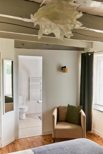a living room with a couch and a ceiling at La Breizhidence in Combourg