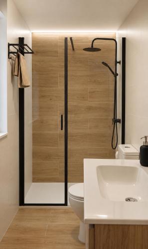 a bathroom with a shower and a toilet and a sink at Casa Candola in Noya