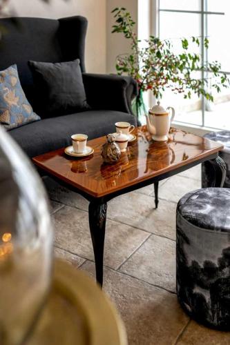 a living room with a coffee table and a couch at Secluded Vineyard Villa With Panoramic Views in Kojsko