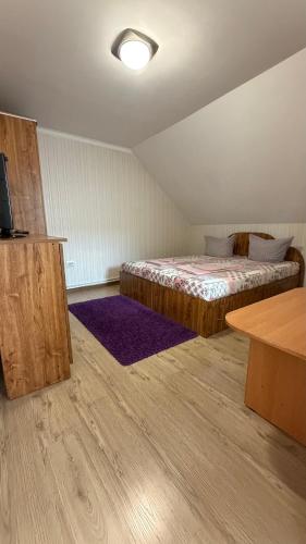 a room with a bed and a table and a tv at Ріточка in Berehove