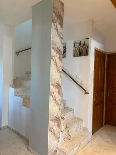 a stone wall in a hallway with a stone staircase at Valenthia in Agios Ioannis Pelio