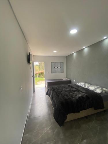 a bedroom with a bed in the middle of it at Pousada San Matheus in São Miguel Arcanjo