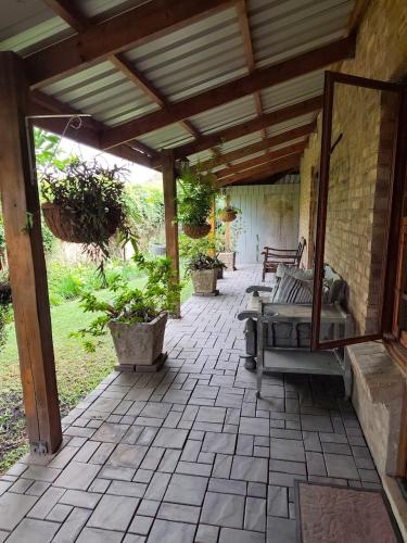 an outdoor patio with benches and a pavilion at Serendipity Garden Studio Gateway to Kruger and Panorama Route in Kampersrus AH