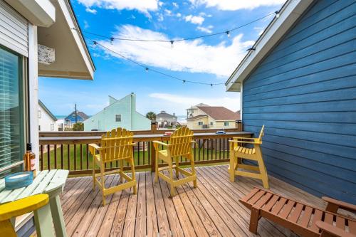 a deck with chairs and a table and a bench at Gulf-View Townhome Hot Tub 2-Min Beach Walk in Galveston