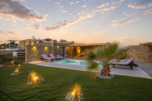 a backyard with a swimming pool and a villa at South Star private Mini Villa in Mikonos