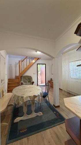 a living room with a table and a staircase at Роман in Berehove