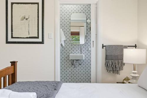a bedroom with a bed and a mirror at Riverbend Escape, Judbury in Judbury