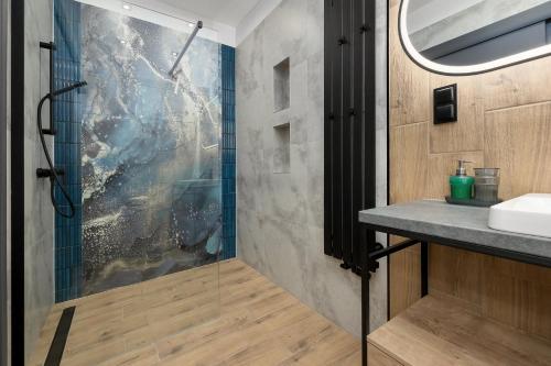 a bathroom with a shower and a sink at Dom Wczasowy Radość in Rewal