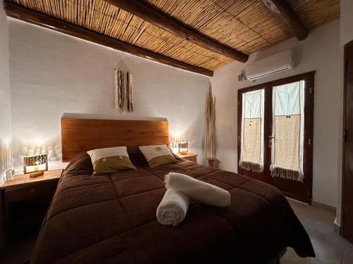 a bedroom with a large bed and two windows at Luna Victoria - apart in Purmamarca