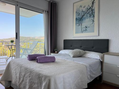 a bedroom with a bed with two pillows on it at Panoramic 4 Apartments 2B in Castelldefels