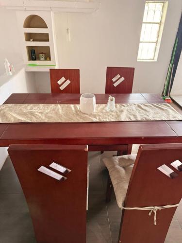 a dining room table with two chairs and a table and chairsuggest at Quinta San Agustin in Latacunga