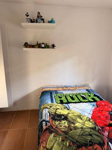 a bedroom with a hulk quilt on a bed at Quinta San Agustin in Latacunga