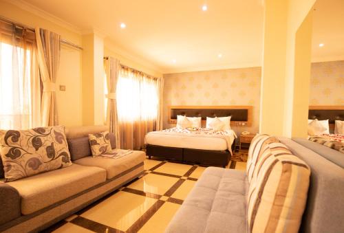 a hotel room with a bed and a couch at West Lerruat Hotel in Nairobi
