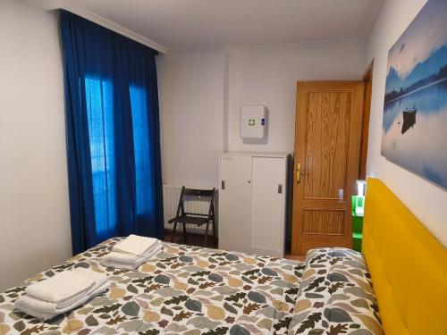 a bedroom with a bed with towels on it at Casa Tia Nieves in Ruiloba