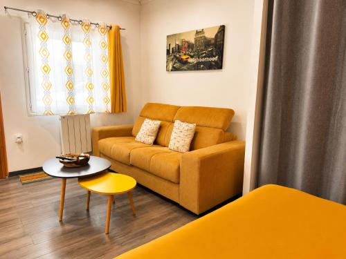 a living room with a couch and a table at Le cocondor - Design soigné et Parking facile in Montréjeau