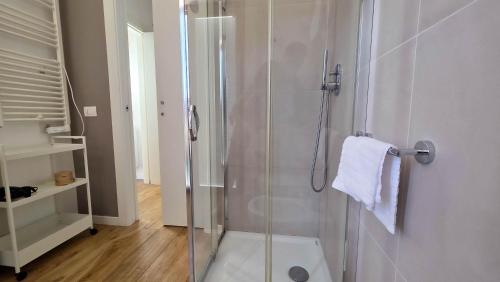 a bathroom with a shower with a glass door at LA PIETRA Residence in Trani