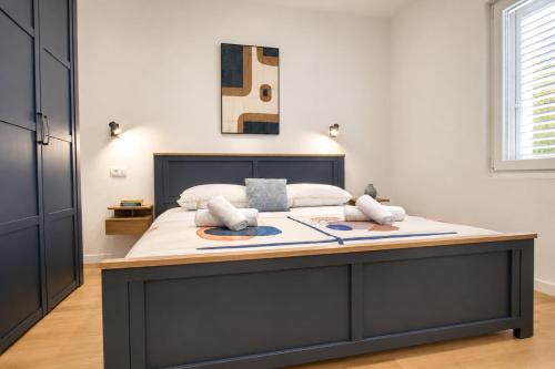 a large bed in a room with a large bedvisor at Luma Luxury Apartment - 5 min Walk to the Beach in Sutomišćica
