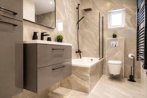 a bathroom with a sink and a toilet and a shower at Luma Luxury Apartment - 5 min Walk to the Beach in Sutomišćica