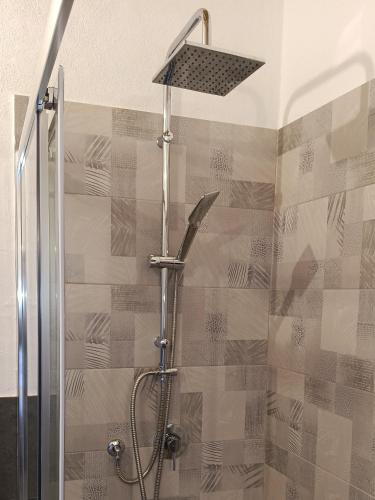 a shower with a shower head in a bathroom at CASALE DILETTOSO Etna Relais in Randazzo