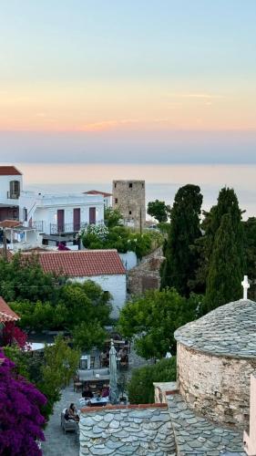 a view of a town with a church and buildings at Casa Milos Windmill Alonissos in Alonnisos