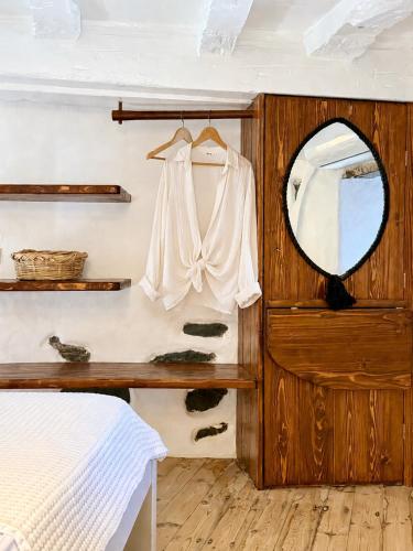 a bedroom with a mirror and a dressing table at Casa Milos Windmill Alonissos in Alonnisos