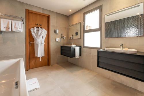 a bathroom with a sink and a mirror at Zephyr Mazagan in El Jadida