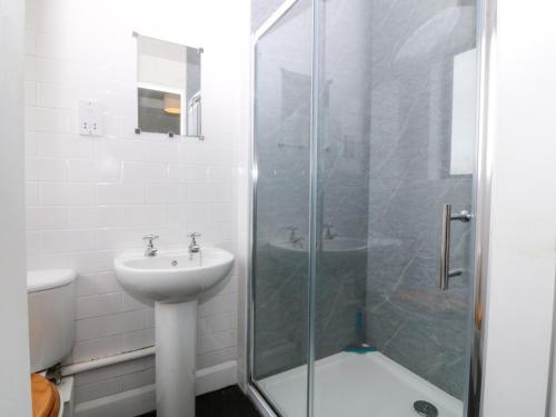 a bathroom with a shower and a sink at Faraway in Rhosneigr