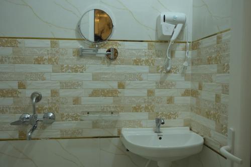 a bathroom with a sink and a mirror at Hotel Surya Inn in Khagaul