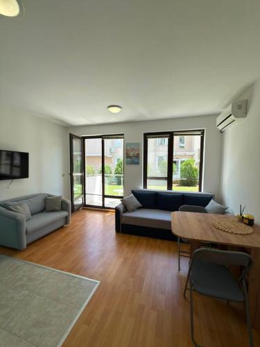 a living room with a couch and a table at Byla Central Studio in Byala
