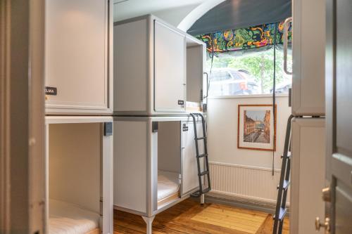 a room with white cabinets and a window at City Backpackers Hostel in Stockholm