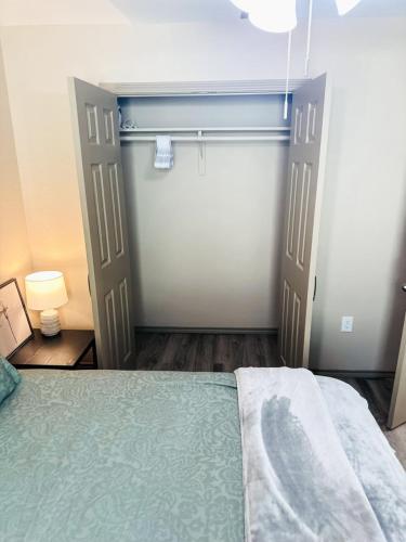 a bedroom with a closet with a bed and a door at Cozy Comfort 1BR - Renovated, Private, Pet Welcome in Texas City