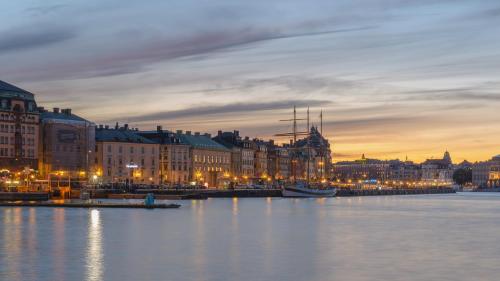 a view of a city with a harbor at night at Hotel Gamla Stan, BW Signature Collection in Stockholm