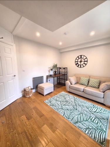 a living room with a couch and a rug at Newly Refurbished Townhouse in Derry Londonderry
