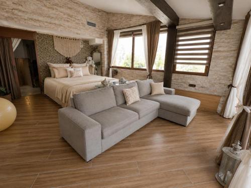 a large bedroom with a bed and a couch at Villa Leo in Bar
