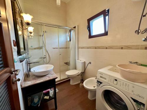 a bathroom with a sink and a washing machine at Villa Leo in Bar