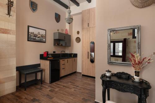 a kitchen with a sink and a mirror at Grand Master Suite in Rhodes Town