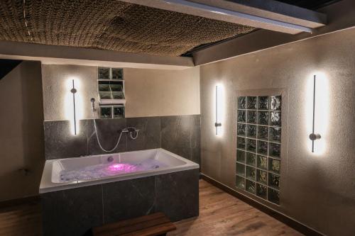 a large bathroom with a tub with a shower at D&C Premium Suites in Pefkochori