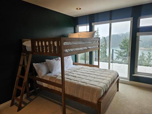 a bedroom with a bunk bed with a ladder at Bowen Island Ocean Retreat in Bowen Island
