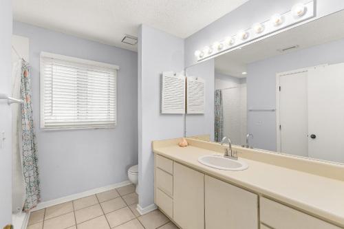a bathroom with a sink and a toilet and a mirror at Madelyn's Oceanview in Tybee Island