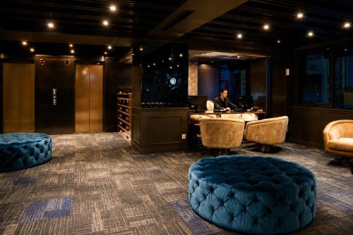 a man sitting at a desk in a wine tasting room at Hotel Relax II in Taipei