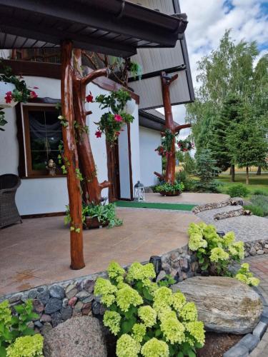 a garden with a pergola and some plants and flowers at Bylew Zacisze in Licheń Stary