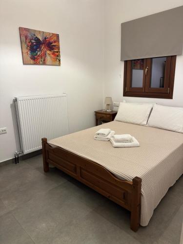 a bedroom with a bed with two towels on it at Pelion Roots in Zagora