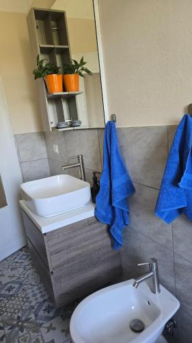 a bathroom with a sink and a toilet and a mirror at Casina Da Vinci in Vinci