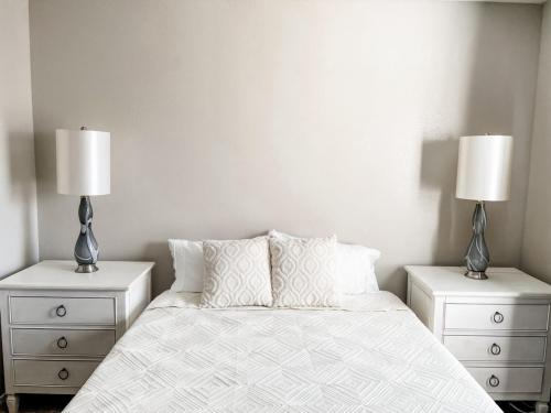 a bedroom with two nightstands and a bed with two lamps at 10 Min to Downtown - Pet-friendly, TV with Parking in Robstown