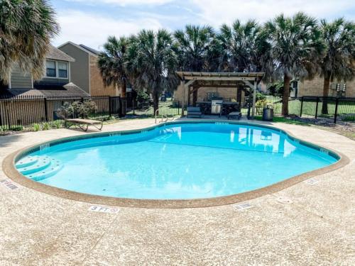 a swimming pool in a yard with palm trees at 10 Min to Downtown - Pet-friendly, TV with Parking in Robstown